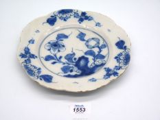 A good mid 18th century English Delft plate, unusually with a scalloped edge,