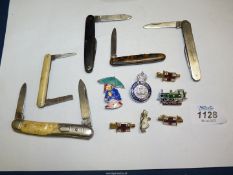 Five early 20th century pocket knives, one with engine turned decoration,