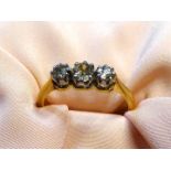 A stamped 18ct gold and 'plat' (platinum) diamond ring set in three stone setting, size 'N 1/2', 3.