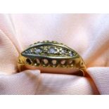 An 18ct gold diamond, boat shaped Ring: five diamonds, Birmingham, date letter 't', maker J.H.