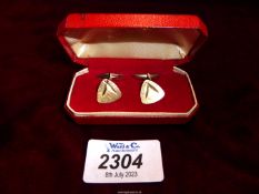 A pair of 9ct gold cufflinks with brushed finish and incised stylised leaf detail.