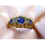 An 18ct gold Engagement ring, two diamonds flanked by central sapphire and two smaller sapphires,