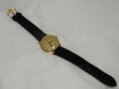 An Omega 9 carat gold cased crown-wound wristwatch of pleasingly plain design having a matt gold
