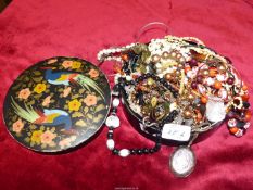 A hand painted tub of costume jewellery including beads, shells, bangles, necklaces etc.