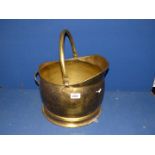 A hammered brass coal bucket.