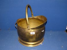 A hammered brass coal bucket.