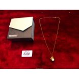 A 9ct gold John McKellar pendant and chain set with a teardrop shape Mother of Pearl overall weight