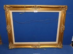 An ornate gilt picture frame, aperture 22" x 16 1/2".