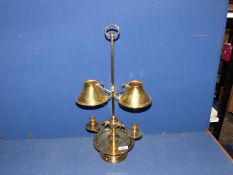 A brass double candlestick with small conical brass shades.
