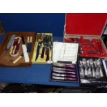 A large quantity of cutlery including cased butter knives, antler handle carving knife and fork,