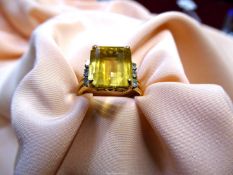 An unmarked Engagement ring with large square cut yellow stone (tourmaline ?),