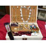 A large Swedish jewellery box with a collection of costume jewellery including necklaces, brooches,