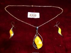 A necklace and earrings set with silver mount and yellow/orange colour stone and a silver chain.