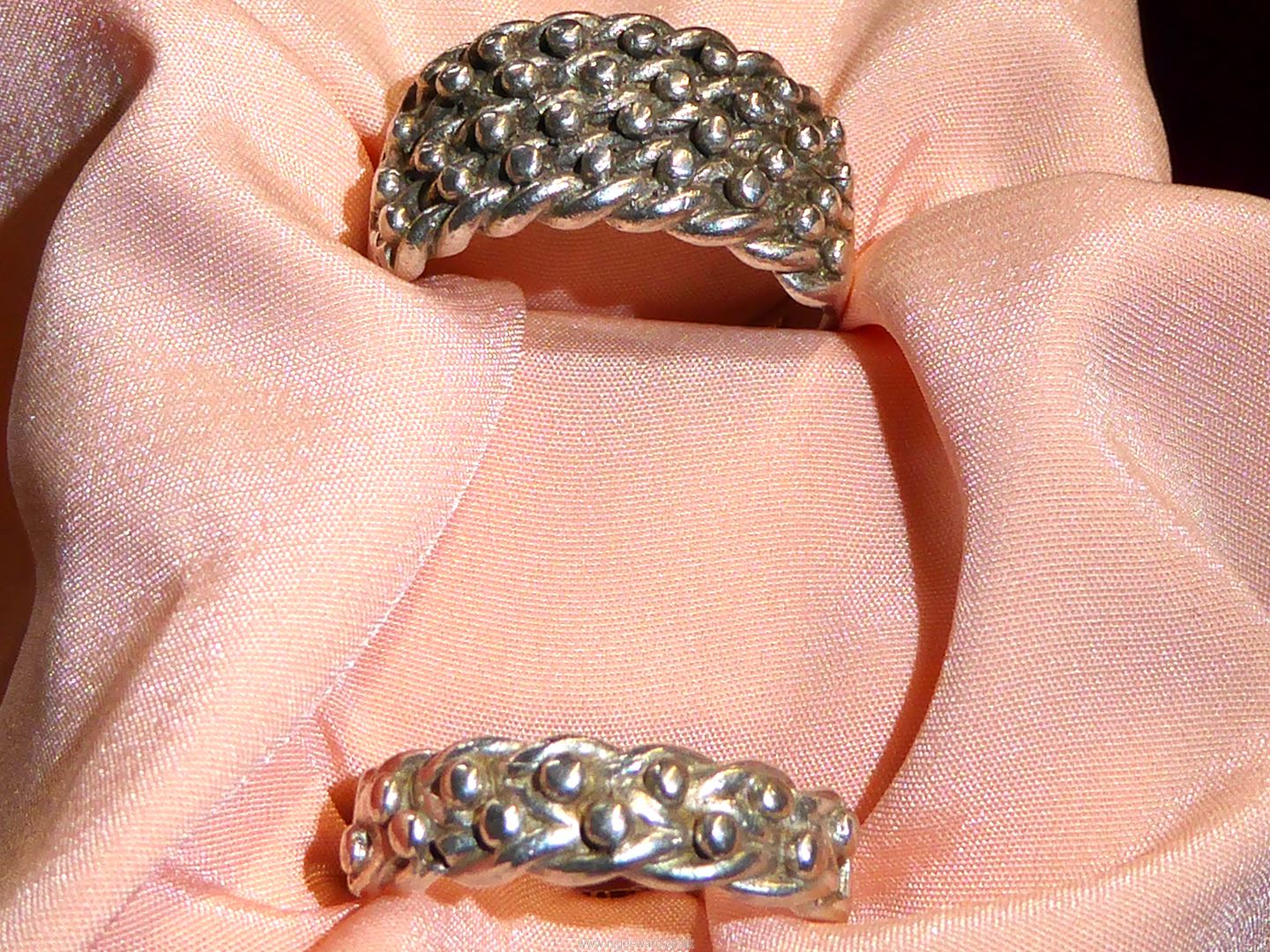 Two stamped 'silver' Keeper rings, one with two braid band, other with four braid,