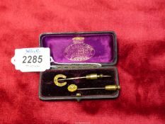 A 15ct Lucky horseshoe Stickpin with four clear stones/chips (three tested as diamonds),