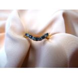 An 18ct gold ring with curve, set alternating five blue stones and four diamonds,size M,