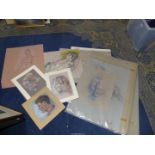 A portfolio of unframed pastel drawings.
