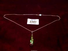 A Jou Jou necklace with a green glass with silver overlay teardrop pendant and a 925 silver chain.