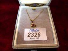 A 9ct gold necklace with a triangle set pink stone and 9ct gold chain from John McKellar,