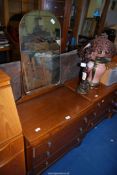A 1950's oak finished dressing table and chest of drawers.