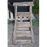 A vintage 4 rung wooden step ladder.