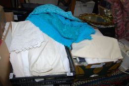 A quantity of table linen, blue blanket, single sheets and pillow cases.