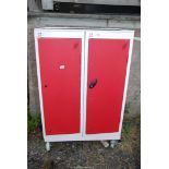 A storage cabinet with shelves on swivel castors, 30" x 18" x 47" high.