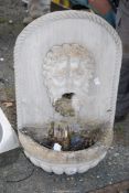 A water feature with figure, and pump, 32" high x 18 1/2" wide.