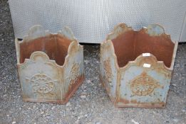 A graduated pair of hexagonal shaped cast iron planters.