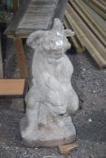 A concrete figure of a putti and fish, 28" high.
