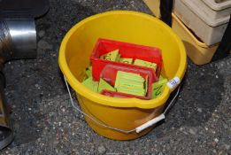 A quantity of plastic tags in a bucket.