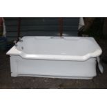 A very heavy cast iron bath with taps and cast iron panels,