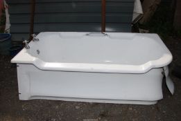 A very heavy cast iron bath with taps and cast iron panels,
