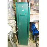 A green metal gun cabinet, (key in office).