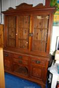 An Oak Dresser having a glazed upper section (Centre pane cracked) and with frieze drawers and a