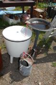 An outdoor drinks chiller, galvanised watering can and a bird bath.