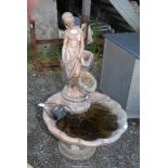 A concrete water feature painted in gilt, with pump, 41 1/2" high x 2' diameter.