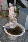 A concrete water feature painted in gilt, with pump, 41 1/2" high x 2' diameter.