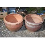 A pair of terracotta planters, 15 1/2" high x 19 1/2" diameter.