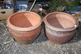 A pair of terracotta planters, 15 1/2" high x 19 1/2" diameter.