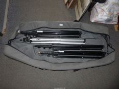 A quantity of photography studio lighting stands, in carrying bag.