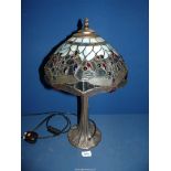 A Tiffany style lamp in blues and greens with dragonfly pattern shade, 20" tall.
