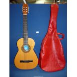 A Spanish acoustic guitar by Classico with soft red case.