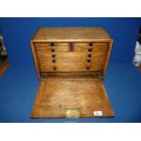 A vintage Oak workman's chest having internal drawers, with key, 17" x 8 1/2" x 11".