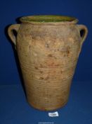 A large Pottery twin handled Pot with green glaze to interior, 14 1/2'' tall, some wear.