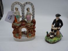 A very good well modelled Staffordshire flatback figure of a couple standing beneath the arches of