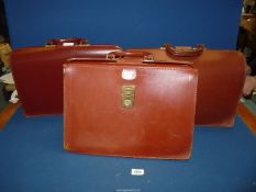 Three brown leather briefcases, one stamped Jennings of Hereford.
