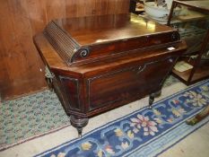 A circa 1900 Mahogany wine cooler standing on turned legs with broad bosses and compact brass