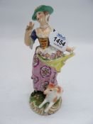 A well modelled and finely detailed porcelain figure of a lady with a bundle of flowers in her