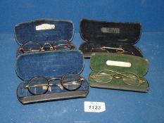 Four pairs of cased spectacles.